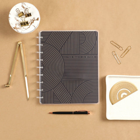 Image of A lifestyle shot of the Realign Classic Notebook by Happy Planner