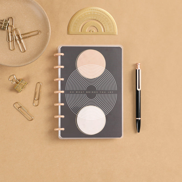 A lifestyle shot of the Realign Mini 12 month planner by Happy Planner